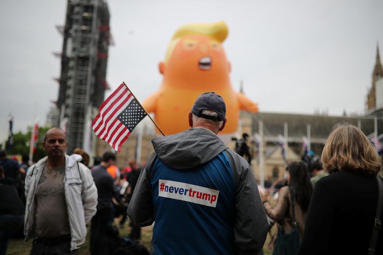 A 'Baby Trump' balloon is seen over demonstrators as they participate in an anti-Trump protest in London June 4