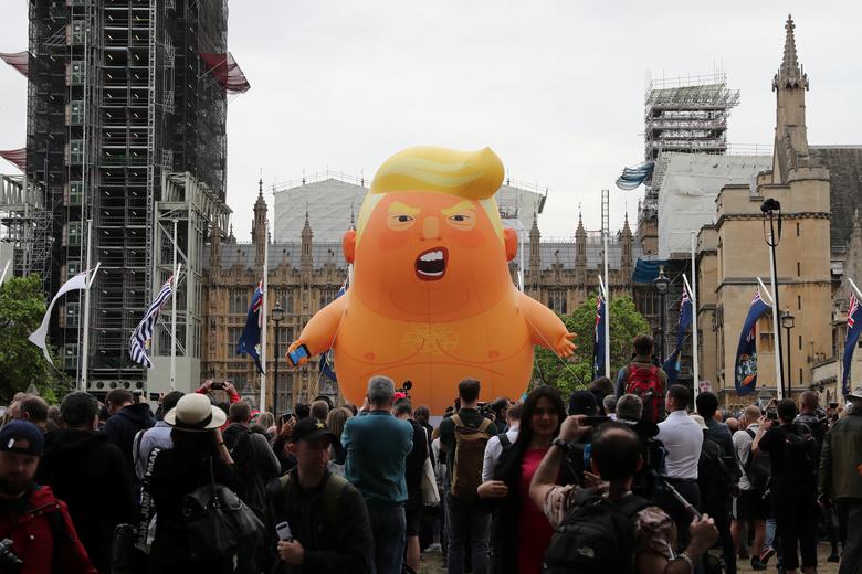 A 'Baby Trump' balloon is seen over demonstrators as they participate in an anti-Trump protest in London, June 4