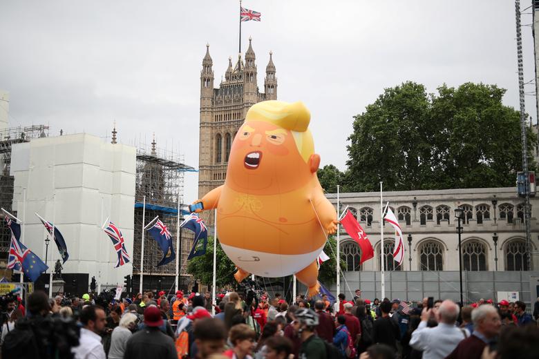 A 'Baby Trump' balloon flies over demonstrators as they take part in an anti-Trump protest in London, June 4