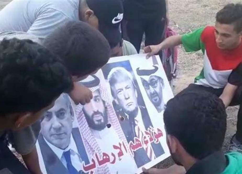 Frame grab from a video recorded by locals shows Palestinian youths setting fire to a poster bearing portraits of (L-R) Israeli Prime Minister Benjamin Netanyahu, US President Donald Trump, Saudi Crown Prince Mohammed bin Salman and the latter’s Emirati counterpart Mohammed bin Zayed Al Nahyan, near the Gaza Strip’s border on June 9, 2019.