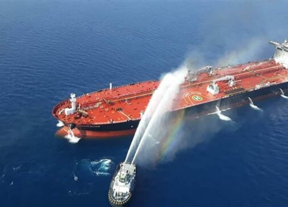 A picture obtained by AFP from Iranian news agency Tasnim on June 13, 2019 shows an Iranian navy boat trying to control fire from the Norwegian-owned Front Altair tanker, on fire in the waters of the Sea of Oman.
