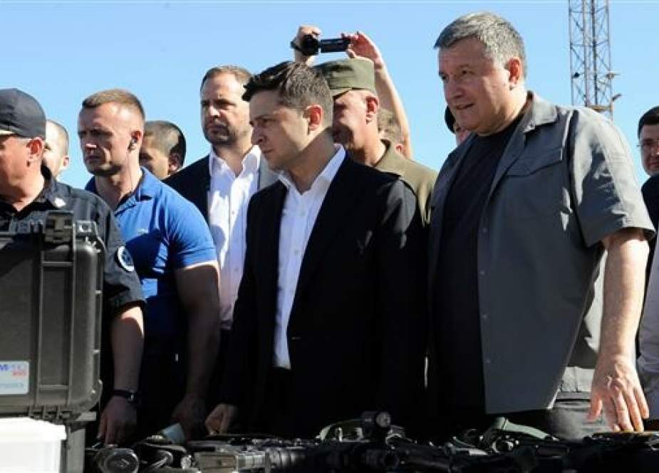 Ukrainian President Volodymyr Zelensky (C) inspects equipment and armaments in the port city of Mariupol during military exercises on June 15, 2019. (Photo by AFP)