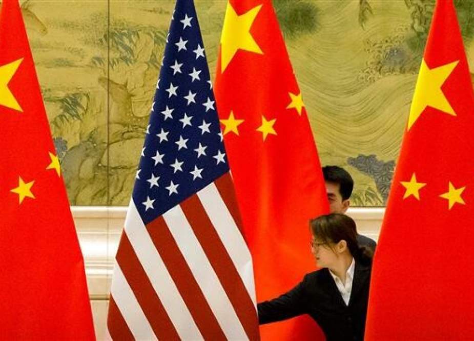 Chinese staff adjust the US and Chinese flags before the opening session of trade negotiations between the US and Chinese trade representatives at the Diaoyutai State Guesthouse in Beijing, China, on February 14, 2019. (Photo by AFP)