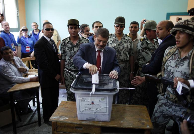 Presidential candidate Mohamed Morsy of the Muslim Brotherhood casts his vote at a polling station in a school in Al-Sharqya, northeast of Cairo June 16, 2012