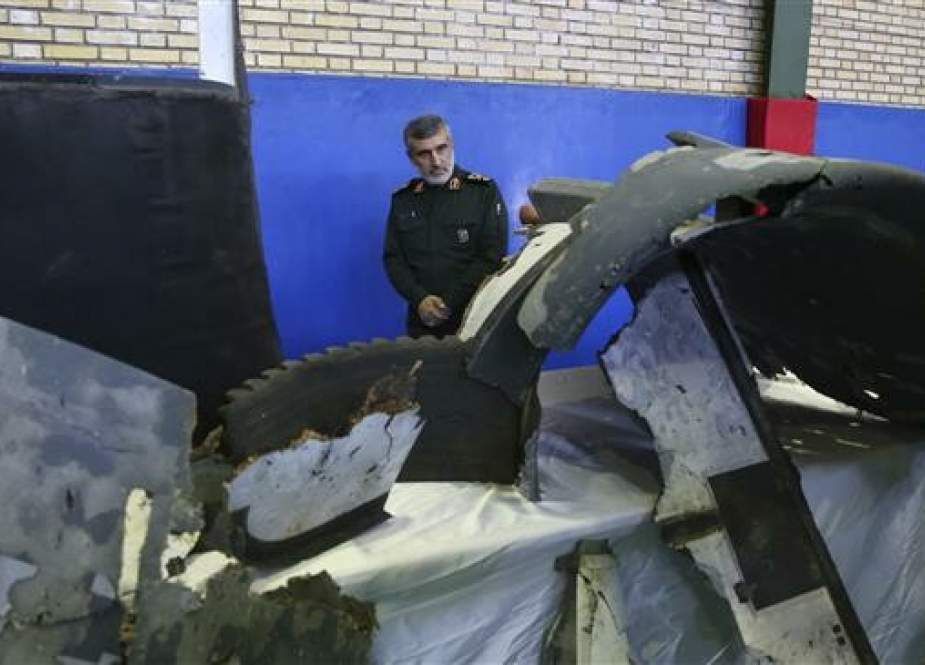 Commander of the Aerospace Division of Iran’s Islamic Revolution Guards Corps (IRGC) Amir Ali Hajizadeh looks at debris from a downed US drone in Tehran on June 21, 2019. (Photo by AP)