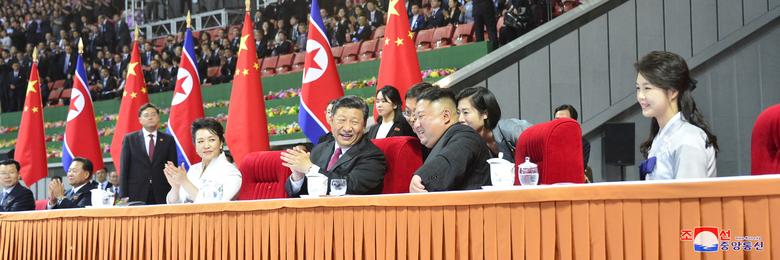 North Korean leader Kim Jong Un, his wife Ri Sol Ju, China's President Xi Jinping and his wife Peng Liyuan attend a mass display during Xi's visit in Pyongyang