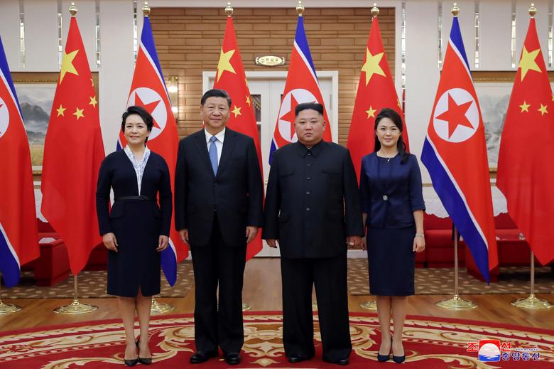 North Korean leader Kim Jong Un and his wife Ri Sol Ju pose for photos with China's President Xi Jinping and his wife Peng Liyuan during Xi's visit in Pyongyang