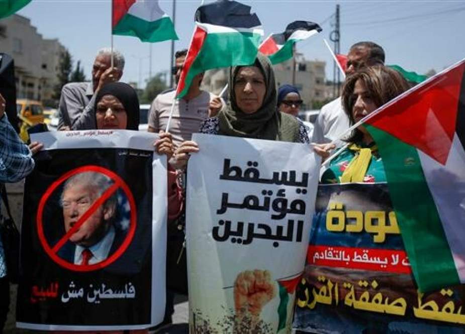 Palestinians hold banners and shout slogans as they rally against the US-led Israeli-Palestinian peace conference in Bahrain scheduled for next week, in Bethlehem in the occupied West Bank on June 20, 2019. (Photo by AFP)