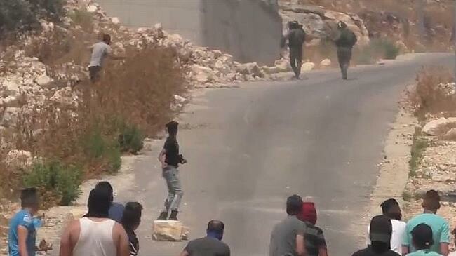 Israeli soldiers fleeing from Palestinian stone-throwers.webp