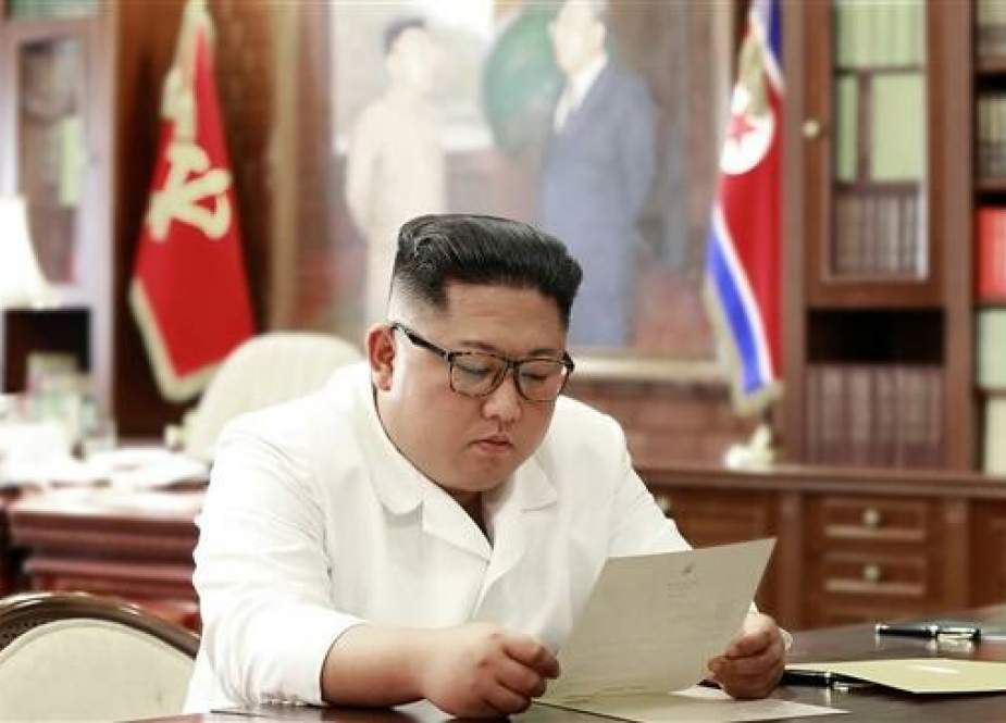 North Korean leader Kim Jong-un reading a personal letter from US President Donald Trump.jpg