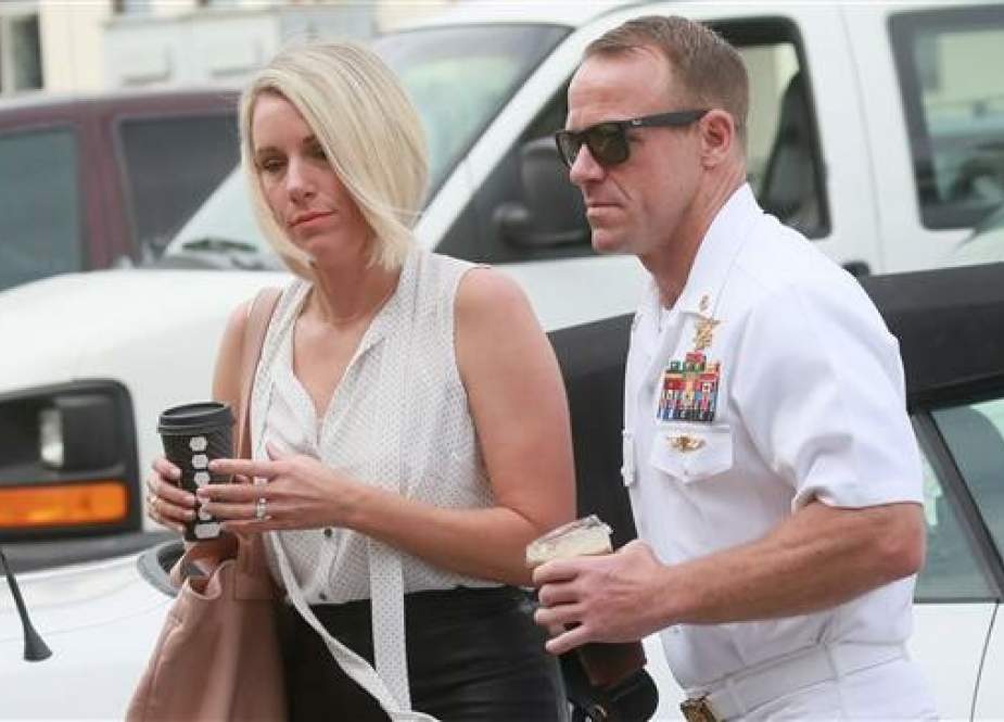 Navy Special Operations Chief Edward Gallagher walks into military court with his wife Andrea Gallagher on June 21, 2019 in San Diego, California. He is accused of multiple counts of war crimes during his deployment to Iraq. (Photo by AFP)