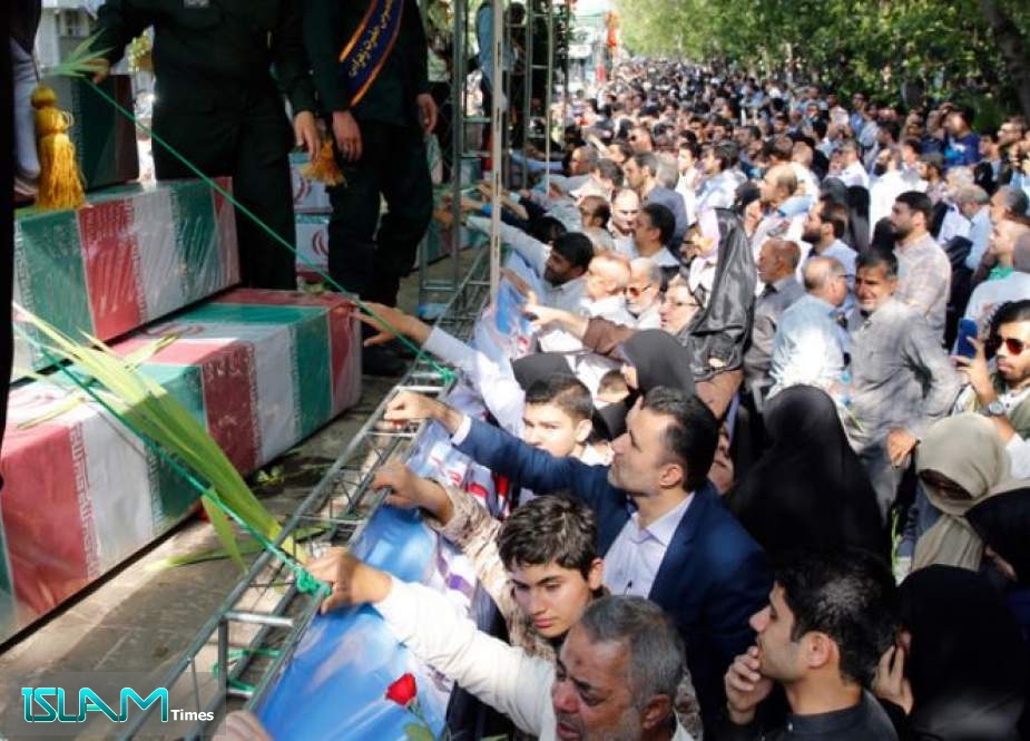 Iranians mourn during a funeral procession for Iranian soldiers killed in the Iran-Iraq war