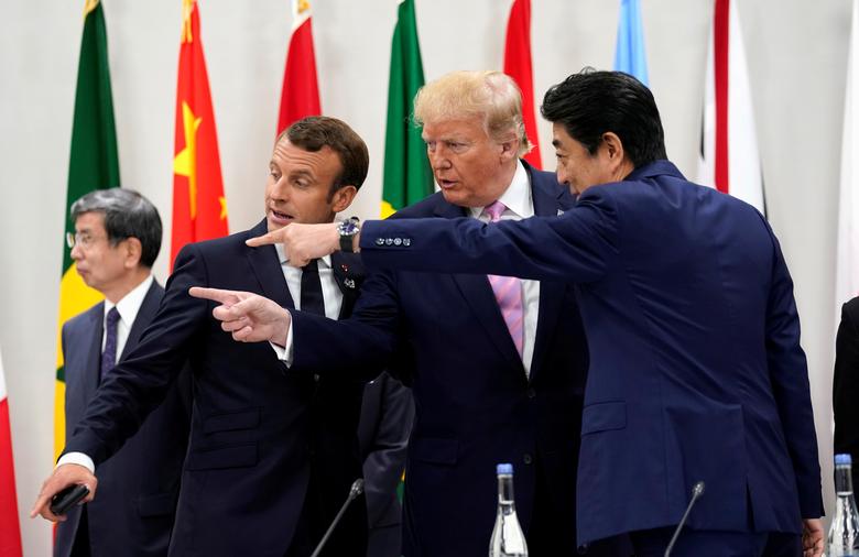 Japan's Prime Minister Shinzo Abe, U.S. President Donald Trump and France's President Emmanuel Macron gesture together during a meeting at the G20 leaders summit in Osaka, Japan, June 28