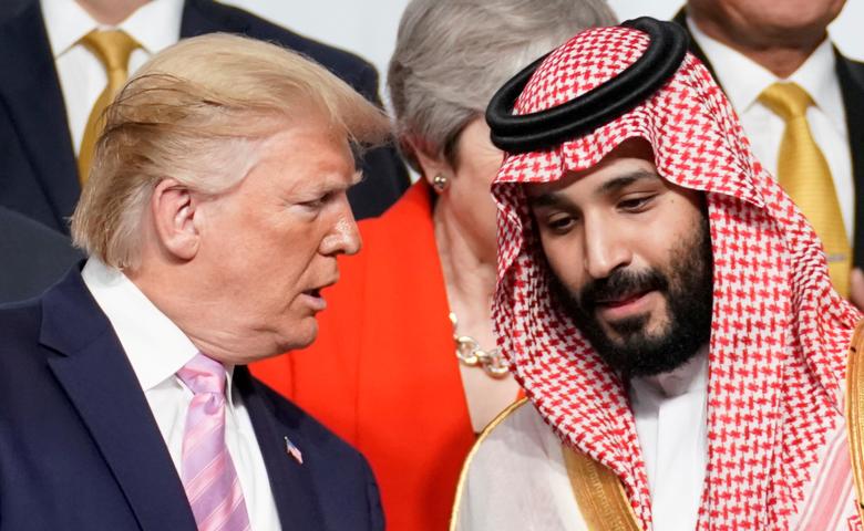 U.S. President Donald Trump speaks with Saudi Arabia's Crown Prince Mohammed bin Salman during family photo session at the G20 leaders summit, June 28