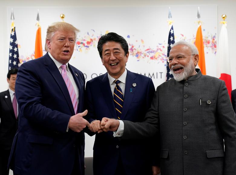 U.S. President Donald Trump, India's Prime Minister Narendra Modi and Japan's Prime Minister Shinzo Abe hold a trilateral meeting during the G20 leaders summit in Osaka, Japan, June 28