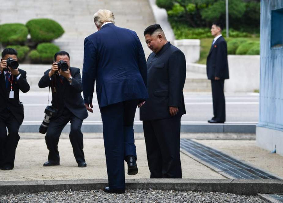 President Donald Trump steps into the northern side of the Military Demarcation Line that divides North and South Korea, as North Korea’s leader Kim Jong Un looks on, in the Joint Security Area (JSA) of Panmunjom in the Demilitarized zone (DMZ) on June 30, 2019.