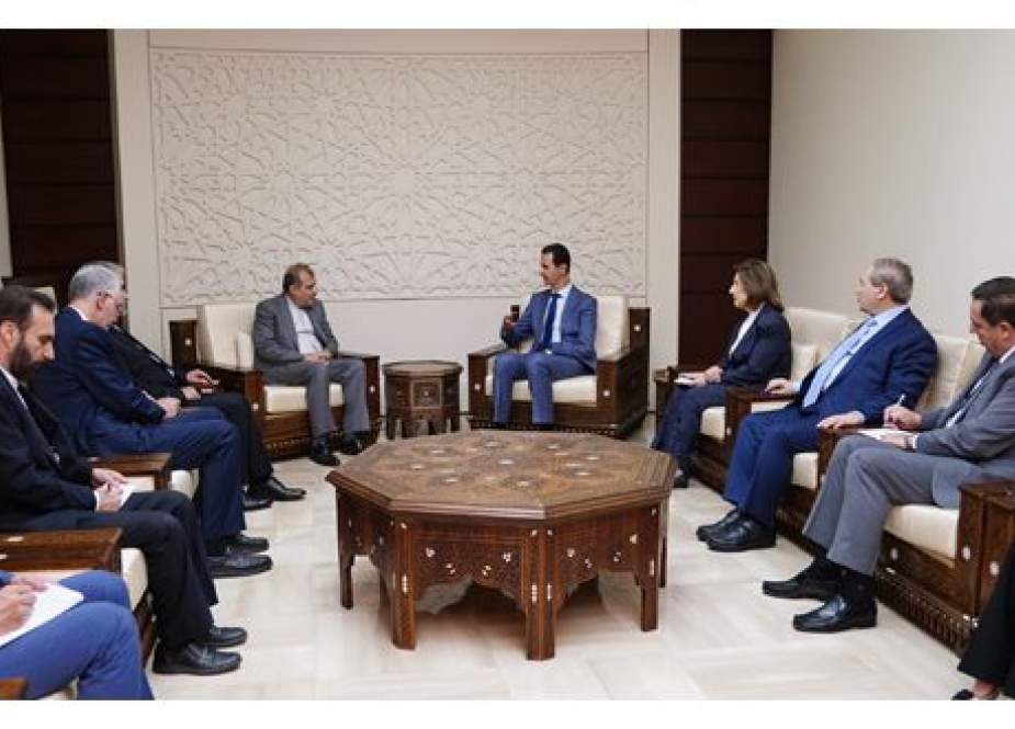 Syrian President Bashar al-Assad with Iranian delegation.jpg