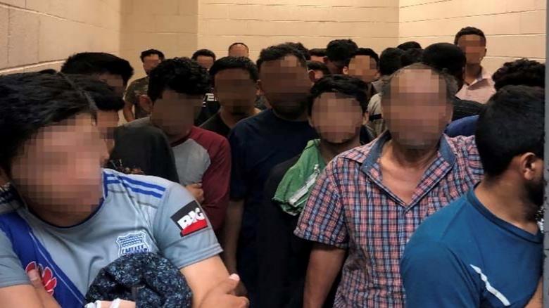 Men are crowded in a room at Border Patrol McAllen Station in a still image from video in McAllen, Texas, on June 10, 2019. Picture pixelated at source