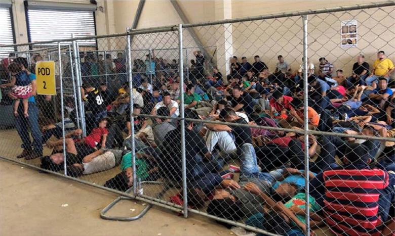 An overcrowded fenced area holding families at Border Patrol McAllen Station is seen in a still image from video in McAllen, Texas, on June 10, 2019. Picture pixelated at source