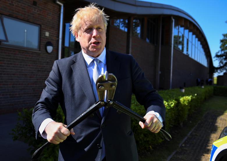 Boris Johnson, a leadership candidate for Britain's Conservative Party, holds a method of entry equipment as he visits the Thames Valley Police Training Centre in Reading, Britain, July 3