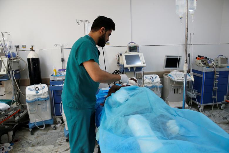 A wounded migrant receives medical care after an air strike hit a detention center for mainly African migrants in Tajoura, in Tripoli Central Hospital, July 3. U.N. human rights chief Michelle Bachelet said it was the second strike on the center during t
