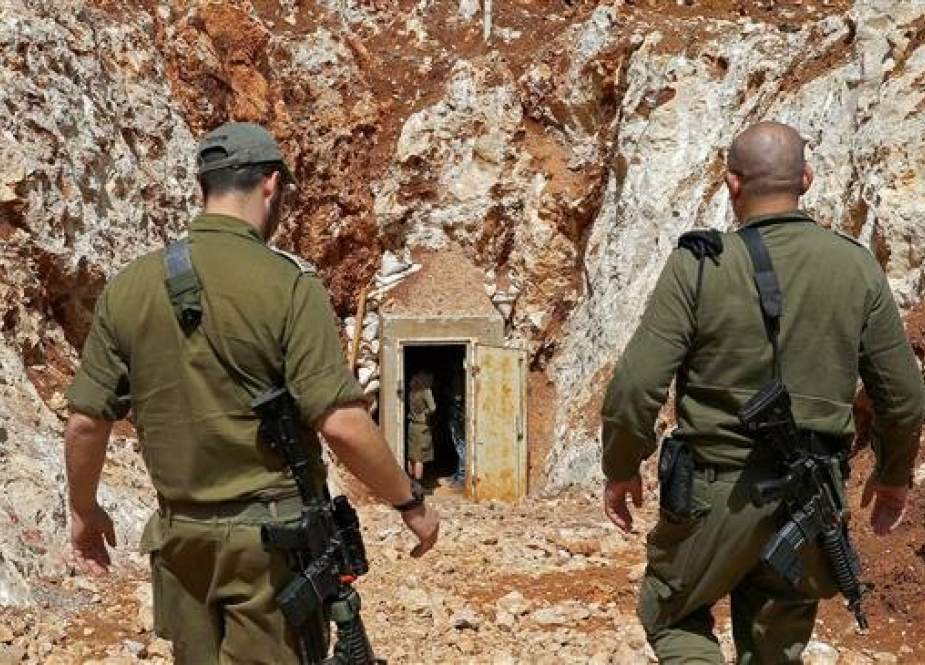 A picture taken on June 3, 2019 during a guided tour with the Israeli military shows soldiers walking near the entrance to a tunnel at the occupied territories