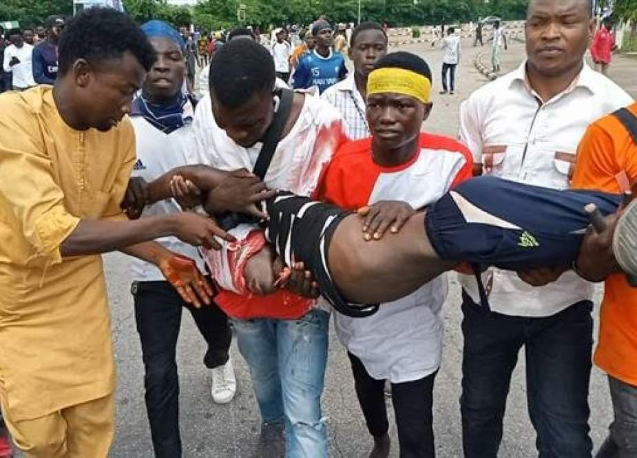 A wounded man is carried away by fellow protesters demanding the immediate release of Nigeria’s senior Muslim figure Sheikh Ibrahim al-Zakzaky in the Nigerian capital, Abuja, on July 9, 2019.