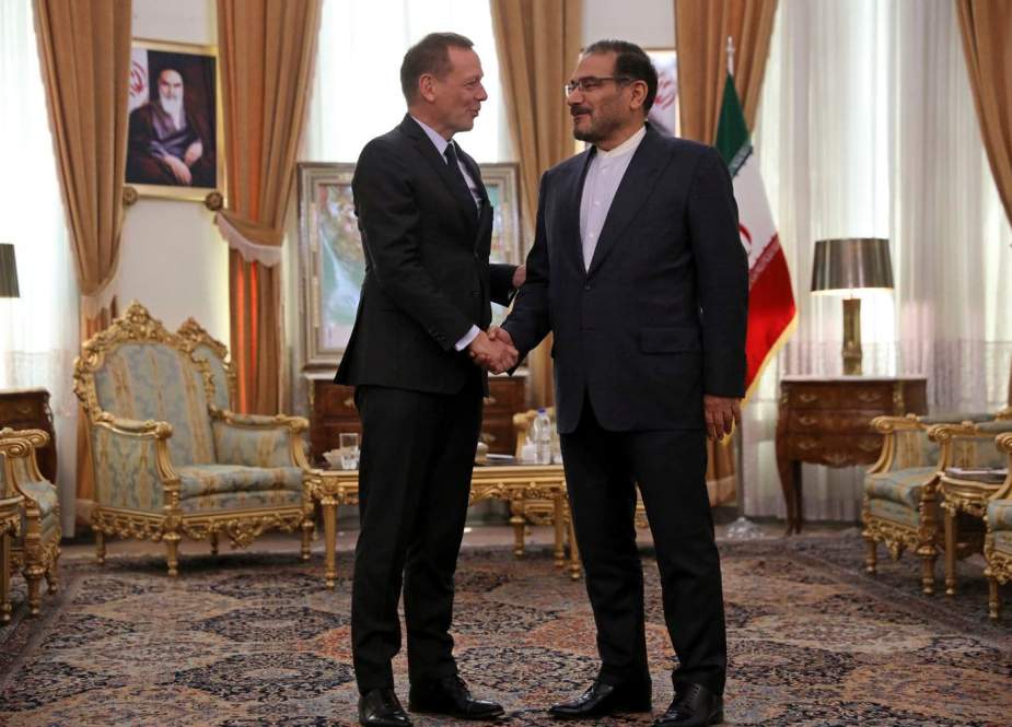 The secretary of Iran’s Supreme National Security Council, Ali Shamkhani (R), and French President Emmanuel Macron