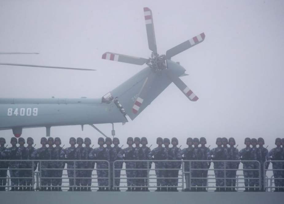 Soldiers stand on deck of the amphibious transport dock Yimen Shan of the Chinese People