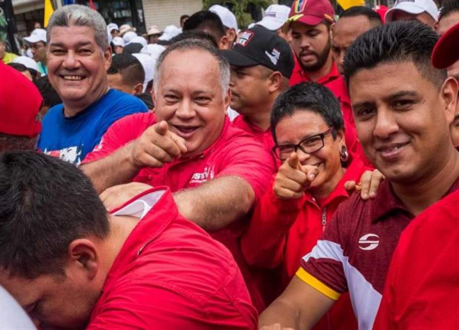 The president of the National Constituent Assembly Diosdado Cabello (C), smiles as he participates in a rally against the recent UN report, in Caracas, on July 13, 2019. (Photo by AFP)