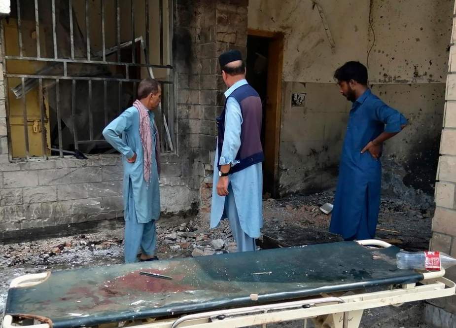 Pakistani security officials examine the site of a bomb attack at the entrance of a hospital in Kotlan Saidan Village on the outskirts of the northwestern city of Dera Ismail Khan, Pakistan, on July 21, 2019.