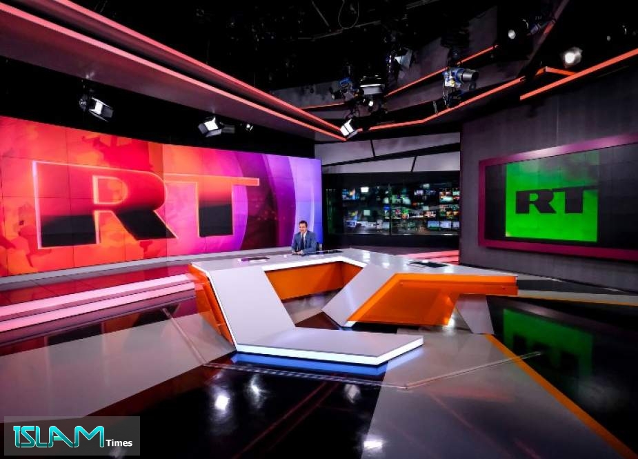 A picture taken on June 8, 2018, shows an unidentified anchor of the Russia Today (RT) TV company as he prepares to go on the air in their studio in Moscow.