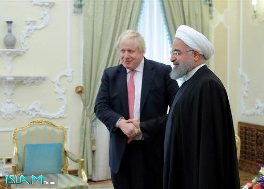 File photo of Iranian President Hassan Rouhani (right) shaking hand with then UK Foreign Secretary Boris Johnson in Tehran on December 9, 2017.