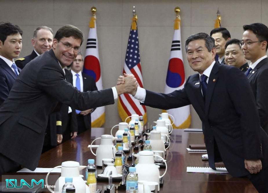 US Secretary of Defense Mark Esper (L) shakes hands with South Korea