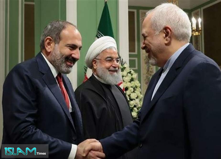 A handout picture provided by the Iranian presidency on February 27, 2019, shows Iranian Foreign Minister Mohammad Javad Zarif (R) receiving Armenian Prime Minister Nikol Pashinyan(L) as President Hassan Rouhani (C) looks on, during a welcoming ceremony in the Iranian capital Tehran.