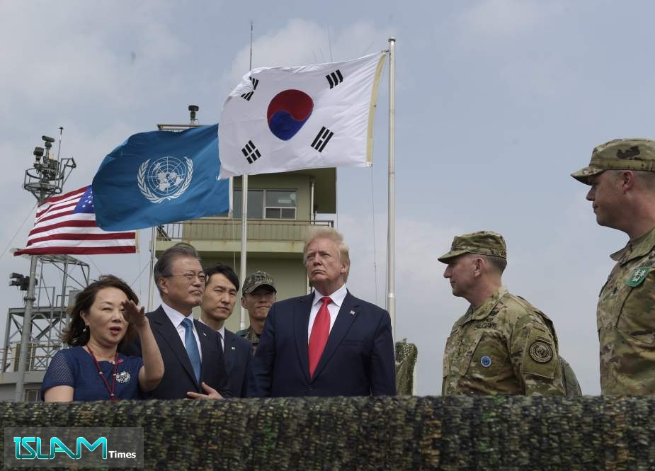US President Donald Trump talks to South Korean President Moon Jae-in at Camp Bonifas, in South Korea