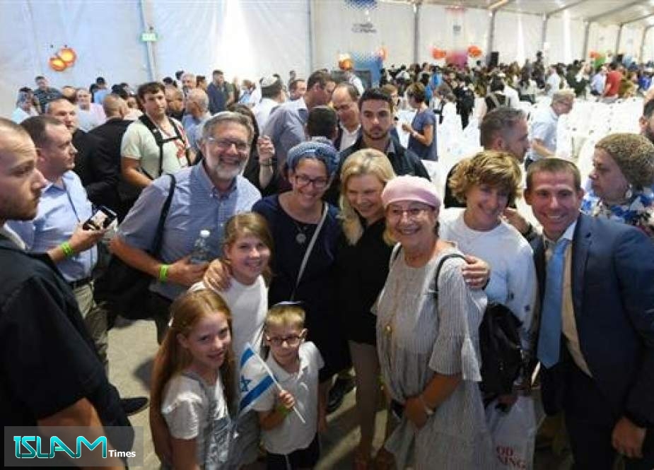 Israeli Prime Minister Benjamin Netanyahu’s wife, Sara, (C) joins the ceremony for new immigrants from the United States and Canada at Ben Gurion Airport in the Israeli-occupied territories on August 14, 2019. (Photo via the English-language Jerusalem Post daily newspaper)