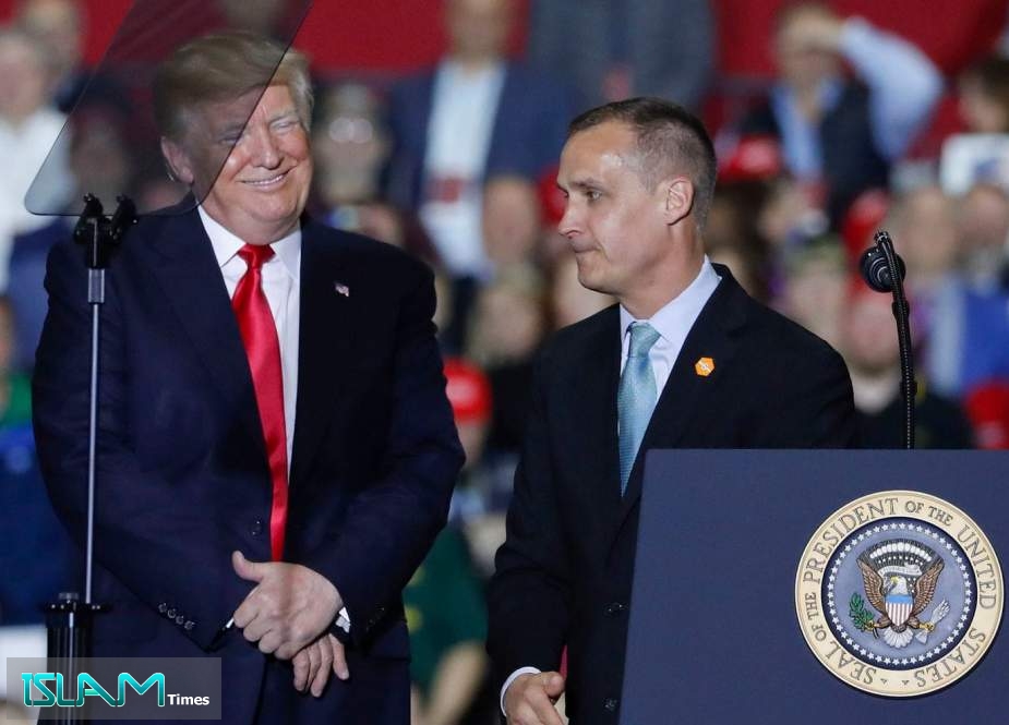 Former Trump Campaign manager Corey Lewandowski speaks as US President Donald Trump looks on during a rally at Total Sports Park in Washington, Michigan on April 28, 2018
