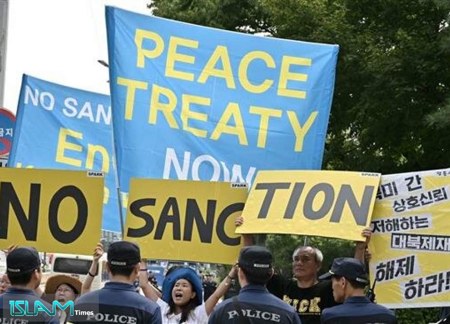 Anti-war activists hold up placards as US special representative for North Korea Stephen Biegun (not pictured) arrives at the Foreign Ministry in Seoul, South Korea, on August 21, 2019.