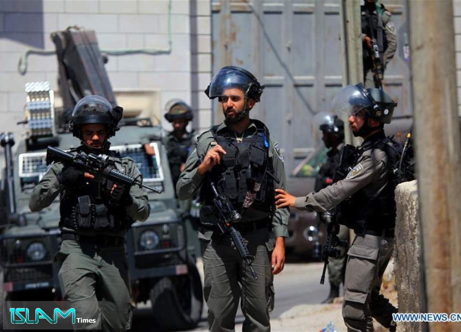 Israeli soldiers stand guard next to the settlement of Migdal Oz in the occupied West Bank on August 8, 2019.