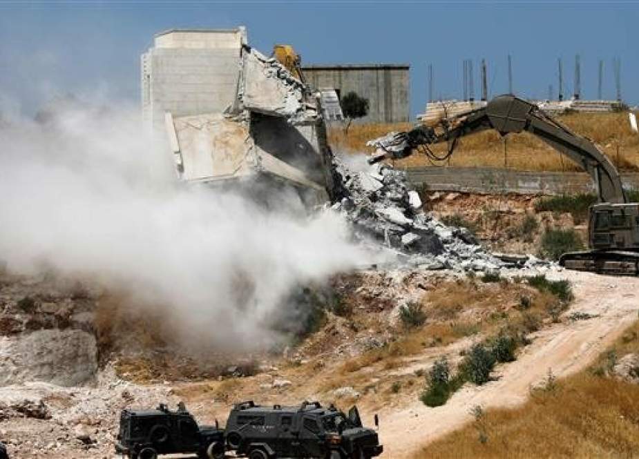 Israeli forces tearing down a Palestinian building in the West Bank village of Dar Salah.jpg