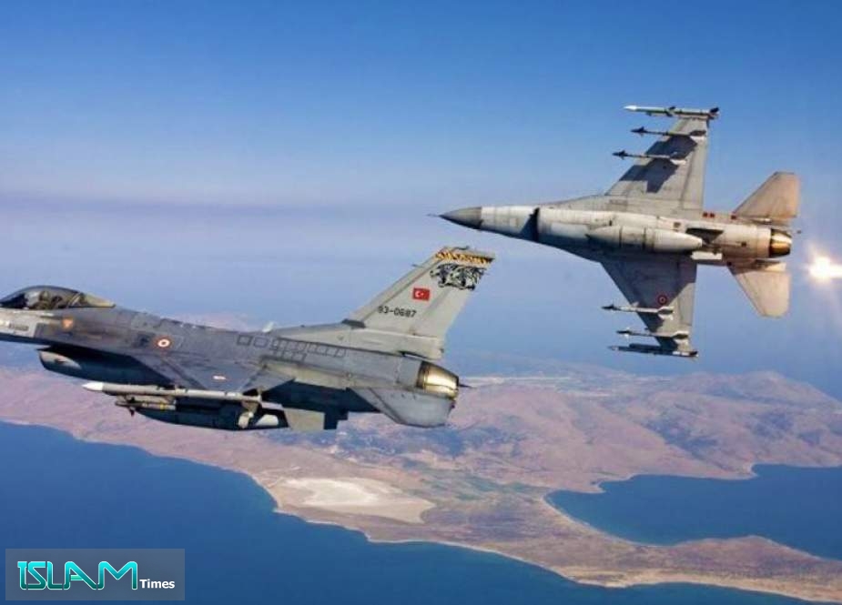 Two F-16 fighter jets operated by the Turkish Air Force in flight.