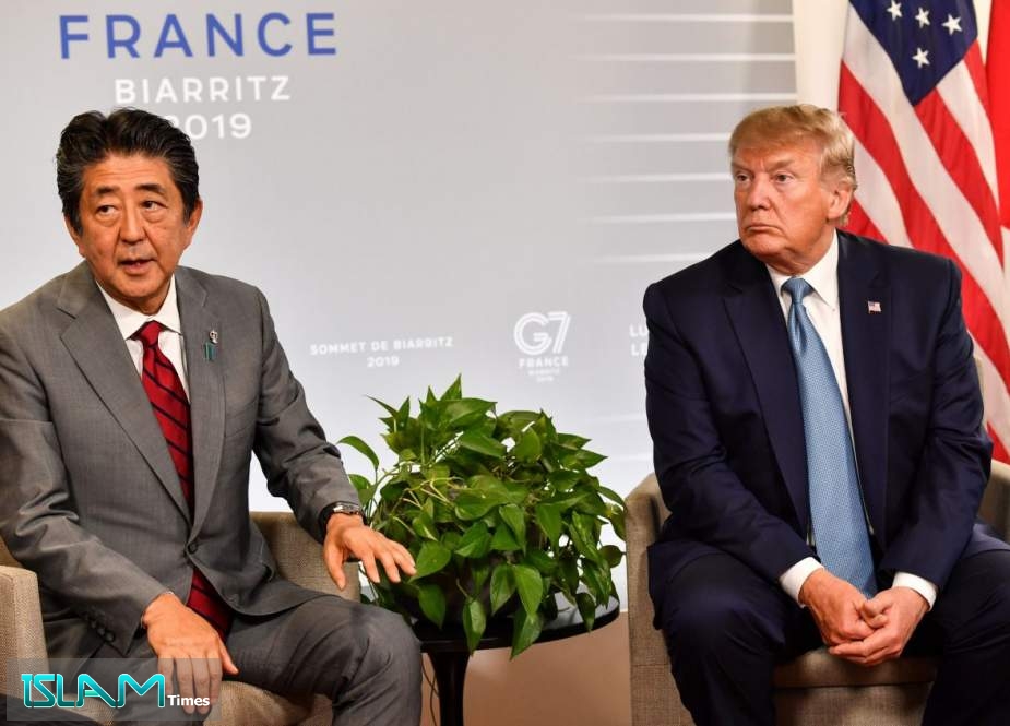 US President Donald Trump (R) reacts as Japan