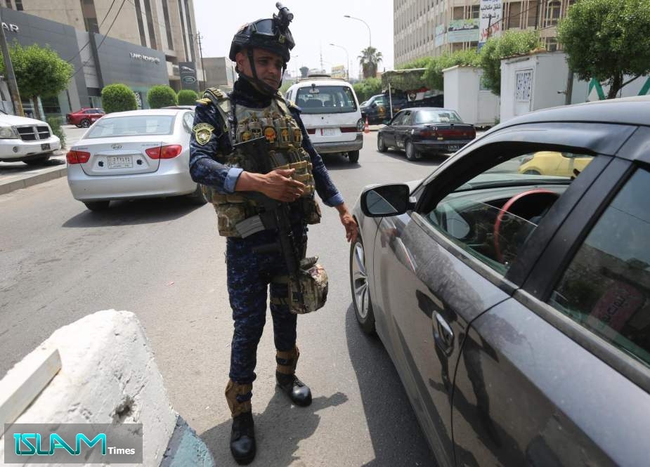 A member of the Iraqi federal police forces is seen at a checkpoint in Baghdad’s Karada district