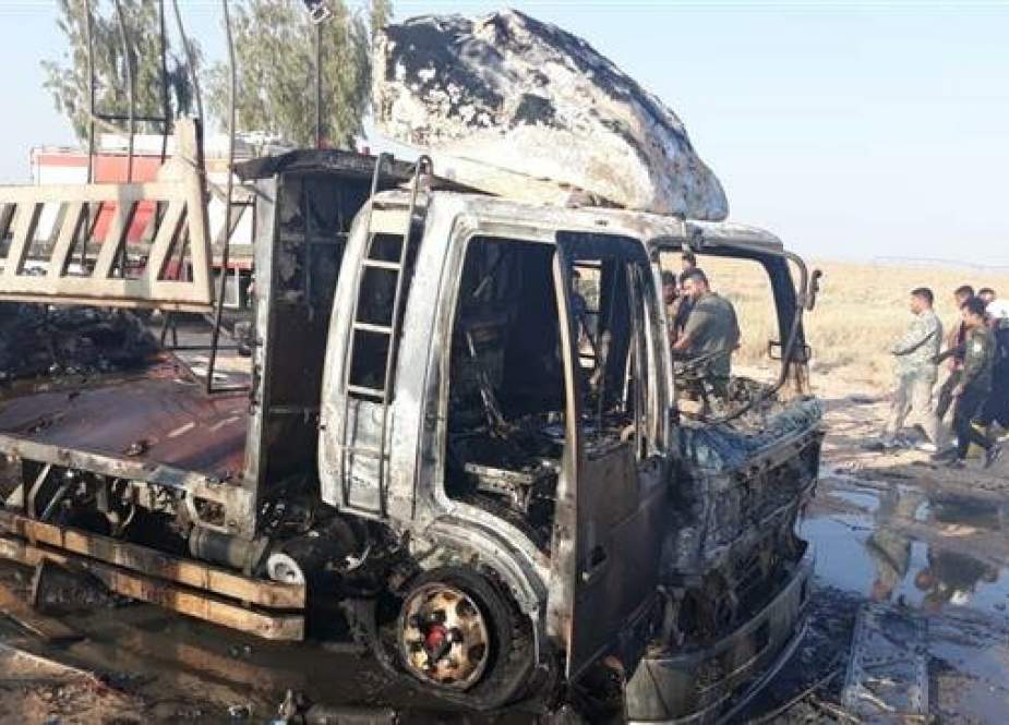 Damaged car of the Popular Mobilization Units after a strike by an unmanned aircraft close to the Syrian border in Anbar, Iraq.jpg