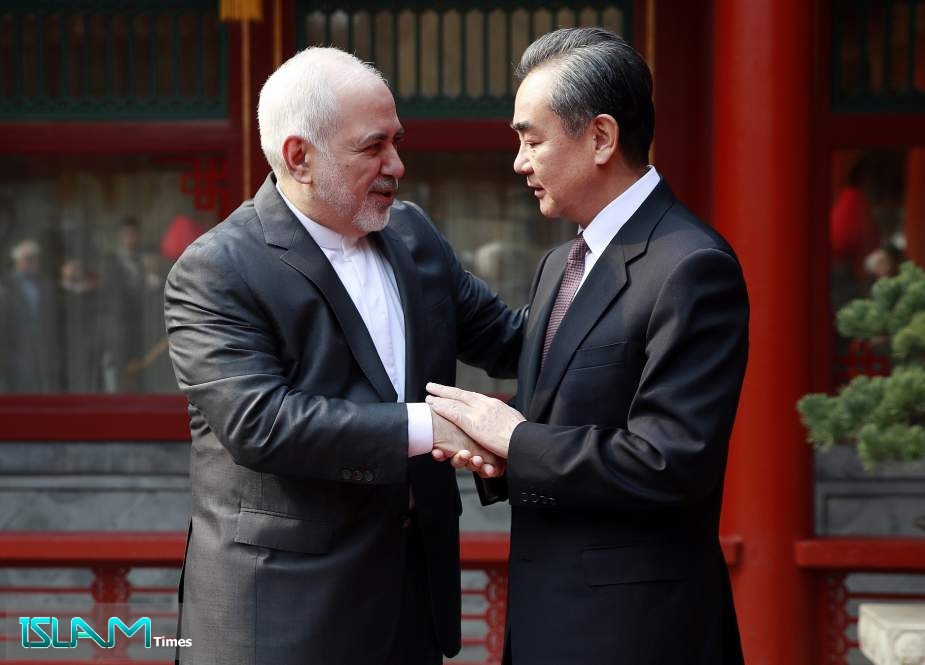 Iranian Foreign Minister Mohammad Javad Zarif shakes hands with his Chinese counterpart Wang Yi