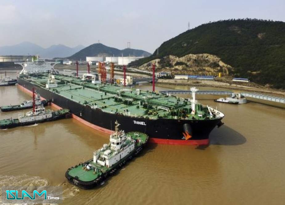 Tugboats dock the oil tanker “Daniel” carrying crude oil from Iran at the port of Zhoushan in China’s Zhejiang province
