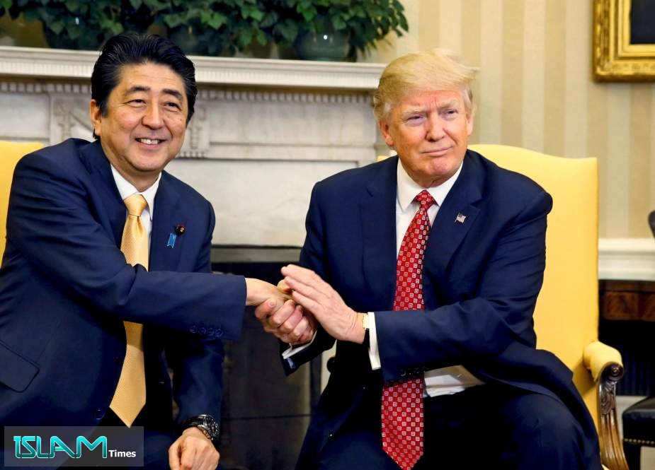 US President Donald Trump shakes hands with Japan