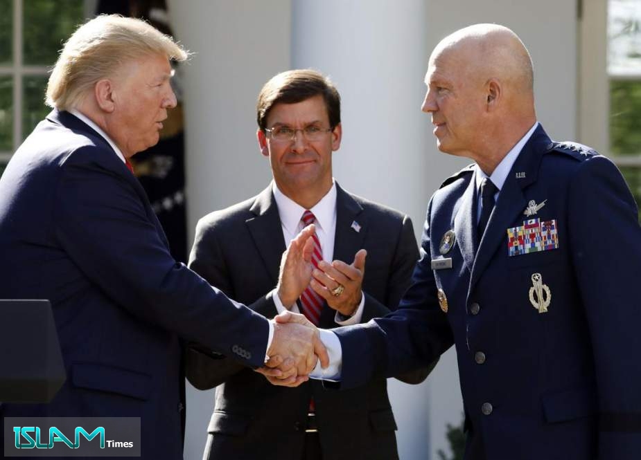 US President Donald Trump shakes hands with US General John W. Raymond
