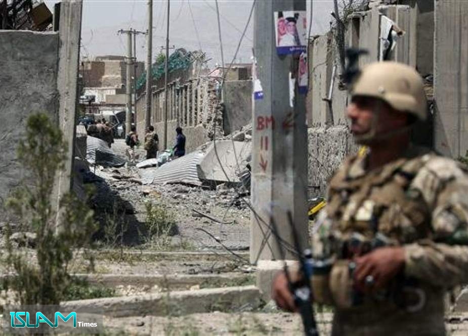 An Afghan security personnel stands guard at the site where a Taliban car bomb detonated at the entrance of a police station in Kabul on August 7, 2019.